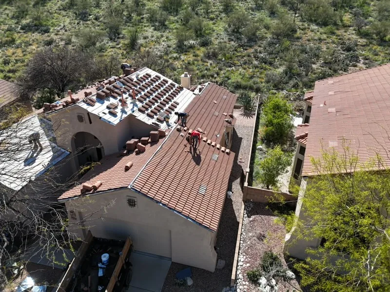Aerial view of DC Roofing crew installing clay tiles on a Tucson residential roof