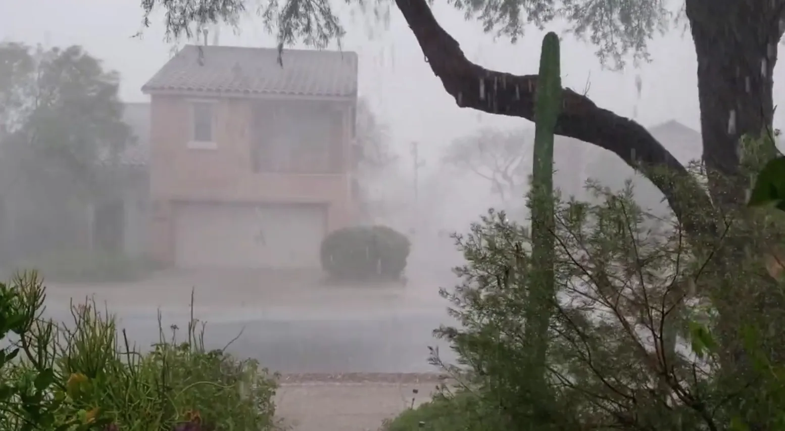 Heavy monsoon rain pouring off a roof in Tucson, Arizona