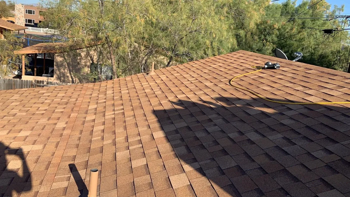 Freshly installed brown asphalt shingle roof on a Tucson home