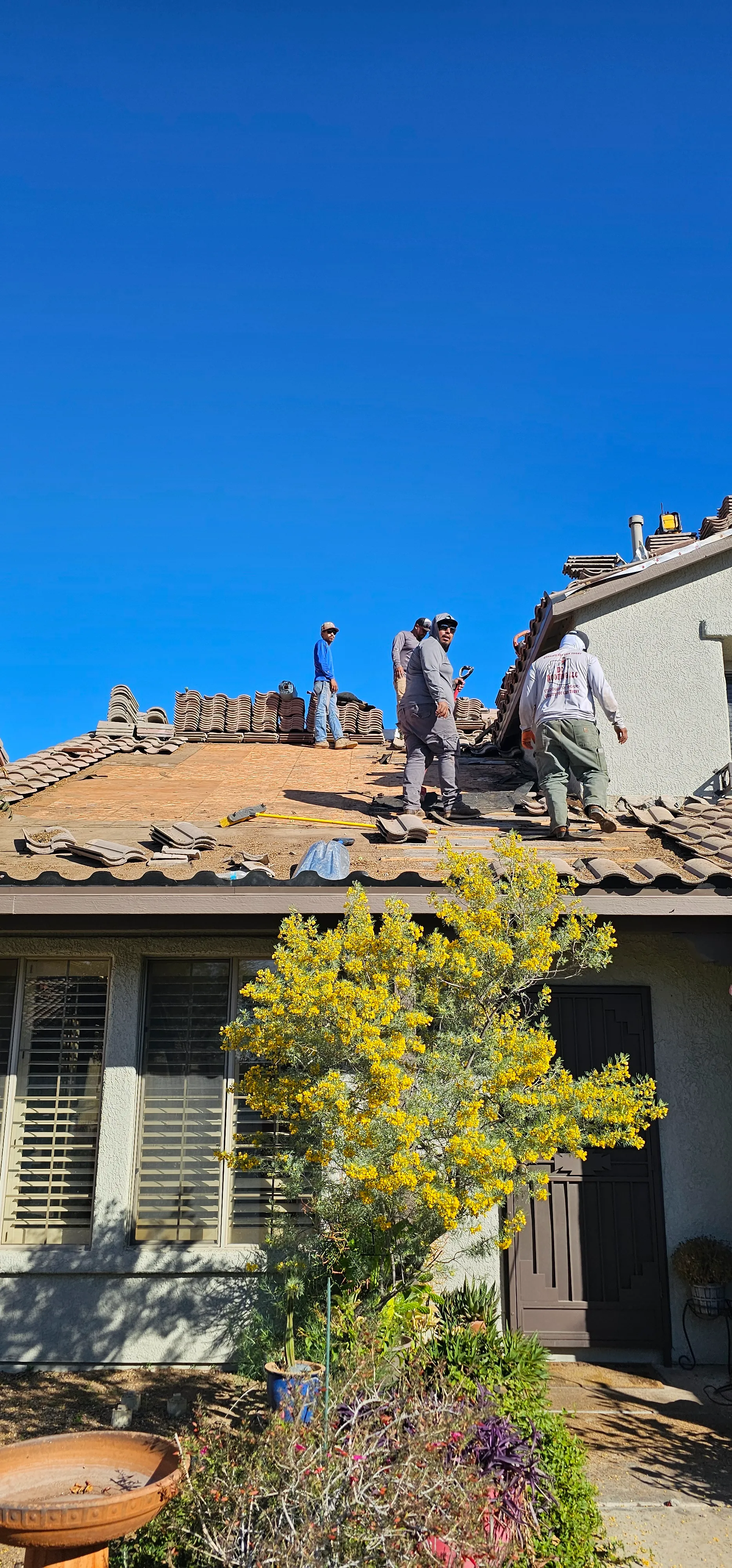 DC Roofing of Arizona crew replacing a tile roof on a Tucson home