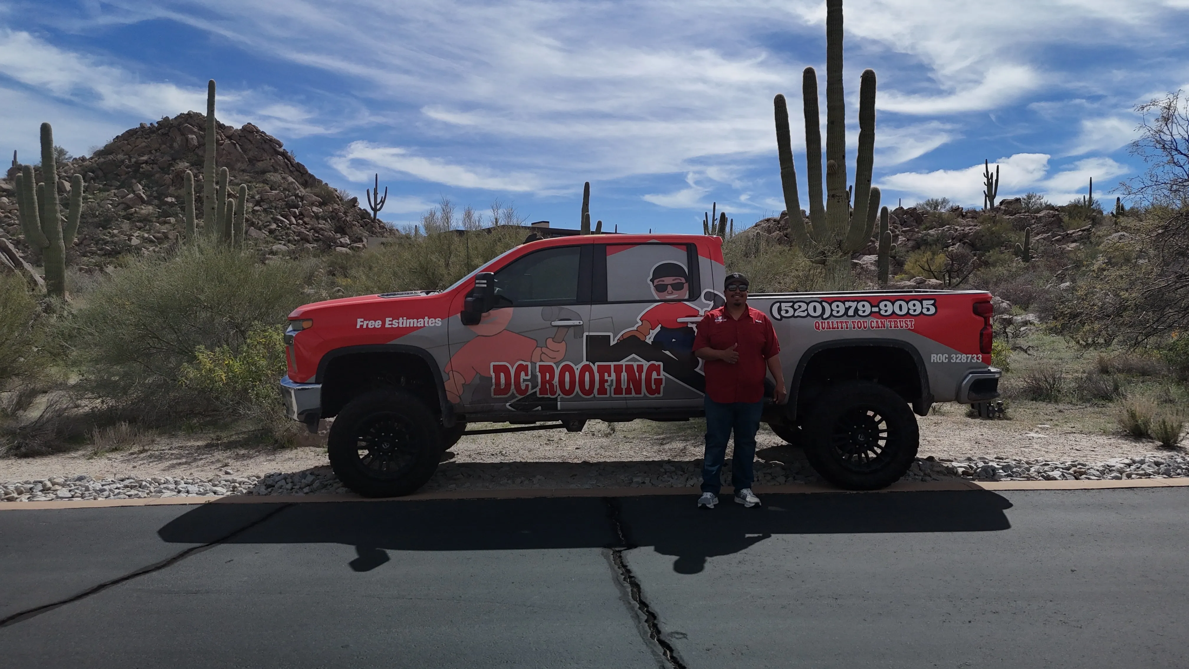 David Contreras, owner of DC Roofing of Arizona, with branded truck in the Sonoran Desert near Tucson