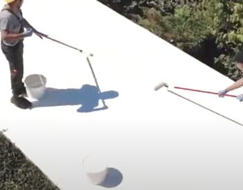 roof restoration systems being rolled on